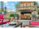 Outdoor fireplace with stone surround, wood storage, seating, and marshmallow roasting supplies for cozy evenings at 7503 S Roanoke St, Gilbert, AZ 85298
