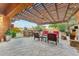 Comfortable outdoor patio with a fireplace, seating, and outdoor kitchen at 7503 S Roanoke St, Gilbert, AZ 85298