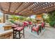Inviting patio with a fireplace, comfortable seating, and outdoor kitchen area at 7503 S Roanoke St, Gilbert, AZ 85298