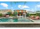 Backyard pool featuring a tanning ledge, water features, manicured landscaping, and patio seating for outdoor relaxation at 7503 S Roanoke St, Gilbert, AZ 85298