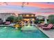 Backyard pool area featuring a pergola-covered patio, beautiful landscaping, and a tranquil fountain feature at 7503 S Roanoke St, Gilbert, AZ 85298