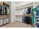 Spacious walk-in closet with ample shelving, multiple hanging rods, and convenient storage solutions at 7503 S Roanoke St, Gilbert, AZ 85298