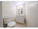 Bathroom featuring a toilet and a white vanity with a mirror at 8023 N 49Th Ave, Glendale, AZ 85302