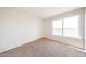 Bright bedroom features a large window and neutral carpet at 8023 N 49Th Ave, Glendale, AZ 85302