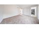 Bright bedroom with neutral carpet, closet, and adjacent bathroom offers a calm space at 8023 N 49Th Ave, Glendale, AZ 85302