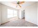 Cozy bedroom features ceiling fan and large window for natural light and airflow at 8023 N 49Th Ave, Glendale, AZ 85302