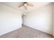 Bright bedroom features a ceiling fan, neutral carpet, and ample natural light at 8023 N 49Th Ave, Glendale, AZ 85302