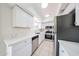 Bright kitchen features stainless steel appliances, white cabinetry, and modern countertops at 8023 N 49Th Ave, Glendale, AZ 85302
