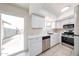 Bright kitchen featuring stainless steel appliances, white cabinets, and backyard access at 8023 N 49Th Ave, Glendale, AZ 85302