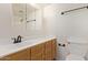 Bathroom features a mirrored vanity, wood cabinets, and updated fixtures at 8155 E Roosevelt St # 205, Scottsdale, AZ 85257