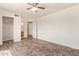 Large bedroom with ceiling fan, wood-look floors, and ensuite bathroom at 8155 E Roosevelt St # 205, Scottsdale, AZ 85257