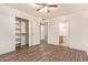 Large bedroom boasts a ceiling fan, wood-look floors, and walk-in closet at 8155 E Roosevelt St # 205, Scottsdale, AZ 85257