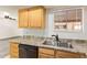 Well-lit kitchen showcases double stainless steel sink and plenty of cabinet storage at 8155 E Roosevelt St # 205, Scottsdale, AZ 85257