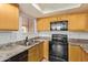 Bright kitchen features stainless steel sink, stone countertops, and ample cabinet space at 8155 E Roosevelt St # 205, Scottsdale, AZ 85257