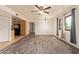 Inviting living room featuring wood floors, modern ceiling fan, neutral paint, and adjacent kitchen at 8155 E Roosevelt St # 205, Scottsdale, AZ 85257