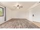 Bright living room features wood floors, modern ceiling fan, neutral paint, and a window with grey curtains at 8155 E Roosevelt St # 205, Scottsdale, AZ 85257
