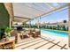 Captivating backyard with a pool, covered patio, outdoor dining area and a unique cactus-themed mural at 8315 E Devonshire Ave, Scottsdale, AZ 85251