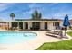 Gorgeous backyard featuring a swimming pool, covered patio, an outdoor dining area and nice landscaping at 8315 E Devonshire Ave, Scottsdale, AZ 85251