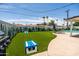 Fun backyard featuring artificial grass, a cornhole game, and a built-in BBQ perfect for outdoor entertaining at 8315 E Devonshire Ave, Scottsdale, AZ 85251