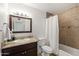 Bathroom featuring granite counters and a shower-tub combo with decorative tile at 8315 E Devonshire Ave, Scottsdale, AZ 85251