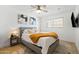 Comfortable bedroom featuring a bed, nightstand, modern art, and plush carpet flooring at 8315 E Devonshire Ave, Scottsdale, AZ 85251