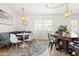 Comfortable dining area with a cozy built-in banquette, modern white chairs, and stylish rug at 8315 E Devonshire Ave, Scottsdale, AZ 85251