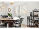 Dining area featuring a wooden table, metal chairs, and natural light from a window overlooking the yard at 8315 E Devonshire Ave, Scottsdale, AZ 85251