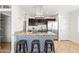 Modern kitchen featuring a breakfast bar with seating, stainless steel appliances, and custom cabinetry at 8315 E Devonshire Ave, Scottsdale, AZ 85251