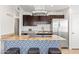 Contemporary kitchen with a breakfast bar, stainless steel appliances, and a stylish geometric pattern at 8315 E Devonshire Ave, Scottsdale, AZ 85251