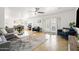Bright living room featuring a cozy seating area, tile floors, and French doors leading to outdoor space at 8315 E Devonshire Ave, Scottsdale, AZ 85251