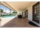 Spacious covered patio with dining set, leading to a private pool and lounge area at 8315 E Devonshire Ave, Scottsdale, AZ 85251