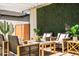 Charming patio area with comfortable seating, a decorative wall and pergola providing shade at 8315 E Devonshire Ave, Scottsdale, AZ 85251