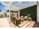 Cozy outdoor seating area under a pergola, adorned with green foliage for a relaxing ambiance at 8315 E Devonshire Ave, Scottsdale, AZ 85251