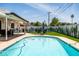 Inviting pool area with lounge chairs, an umbrella, outdoor games, a grill and a cactus mural at 8315 E Devonshire Ave, Scottsdale, AZ 85251