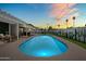 Backyard pool at dusk offers a refreshing escape, enhanced by desert landscaping and covered patio at 8315 E Devonshire Ave, Scottsdale, AZ 85251