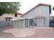 Enclosed patio, privacy fencing, and rock landscaping in this backyard at 909 W San Mateo Ct, Gilbert, AZ 85233