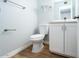 Powder room featuring a toilet and vanity with white cabinetry at 909 W San Mateo Ct, Gilbert, AZ 85233