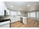Stylish kitchen boasts white cabinets, stainless steel appliances, and a spacious island, seamlessly flowing into dining area at 909 W San Mateo Ct, Gilbert, AZ 85233