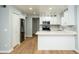 Bright kitchen features white cabinets, stainless steel appliances, stylish backsplash, and a breakfast bar at 909 W San Mateo Ct, Gilbert, AZ 85233