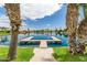 Dock overlooking a serene lakefront with lush landscaping, perfect for waterfront living at 909 W San Mateo Ct, Gilbert, AZ 85233