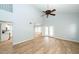 Open-concept living area with wood floors, vaulted ceiling, and access to both the kitchen and outdoor patio at 909 W San Mateo Ct, Gilbert, AZ 85233