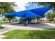 Community playground featuring modern equipment, shade structure, and accessible walkways at 909 W San Mateo Ct, Gilbert, AZ 85233