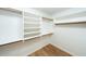 Walk-in closet with white shelving and wood flooring at 909 W San Mateo Ct, Gilbert, AZ 85233