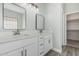 Bathroom featuring dual sinks with quartz countertops, and white cabinetry at 9224 W Raymond St, Tolleson, AZ 85353