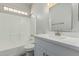 Bathroom featuring single sink vanity with tiled shower and tub at 9224 W Raymond St, Tolleson, AZ 85353