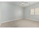 Neutral bedroom with plush carpeting, light walls, and ample natural light at 9224 W Raymond St, Tolleson, AZ 85353