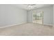 Bright bedroom with neutral carpet and sliding glass doors leading to backyard at 9224 W Raymond St, Tolleson, AZ 85353