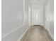 Bright hallway featuring wood floors and a decorative glass front door at 9224 W Raymond St, Tolleson, AZ 85353