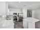 Modern kitchen with stainless steel appliances, white cabinets, and quartz countertops at 9224 W Raymond St, Tolleson, AZ 85353