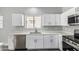Bright kitchen featuring stainless steel appliances and white cabinets, and quartz countertops at 9224 W Raymond St, Tolleson, AZ 85353